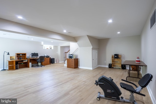 workout room featuring light wood-style flooring, baseboards, and recessed lighting