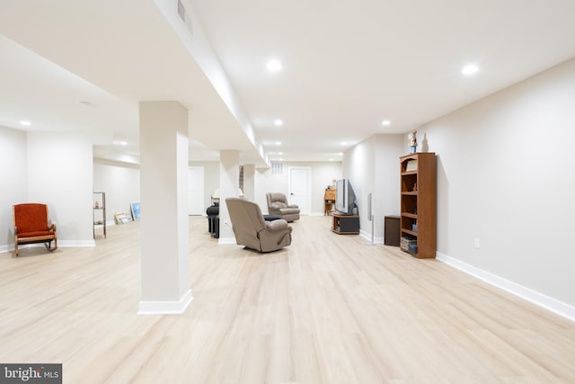 living area with baseboards, visible vents, light wood-style flooring, stairs, and recessed lighting