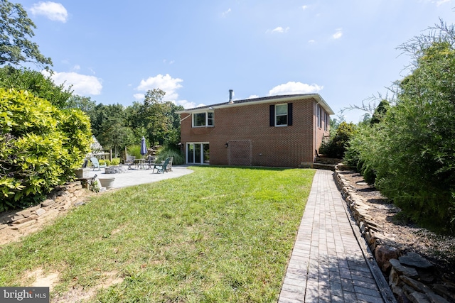 back of property featuring a patio and a yard