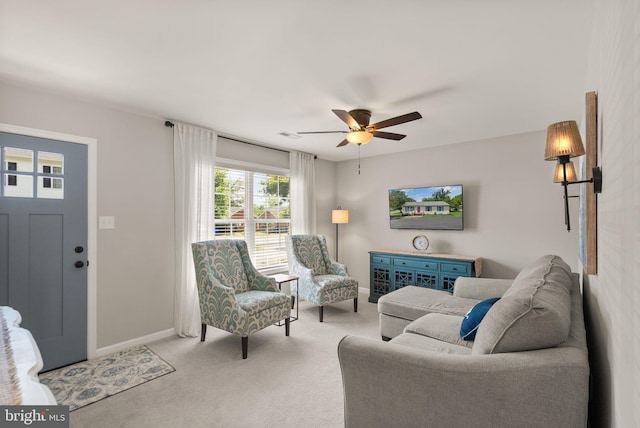 carpeted living room with ceiling fan