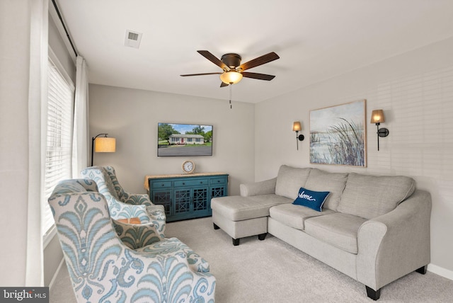 carpeted living room featuring ceiling fan