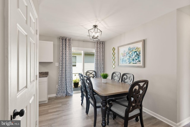 dining room featuring a notable chandelier and light hardwood / wood-style floors