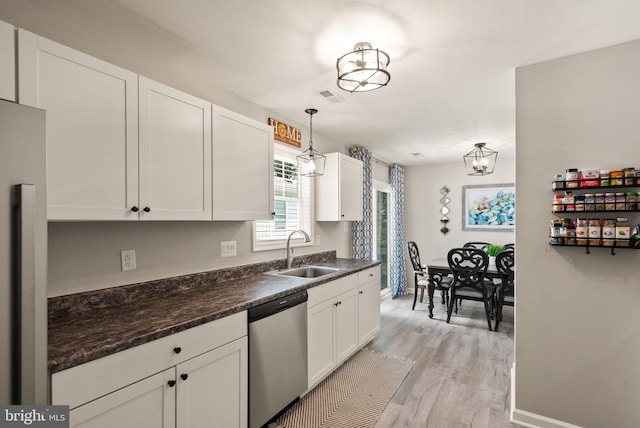 kitchen featuring stainless steel appliances, sink, white cabinets, and light hardwood / wood-style floors