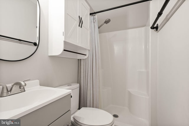 bathroom featuring vanity, toilet, and a shower with shower curtain