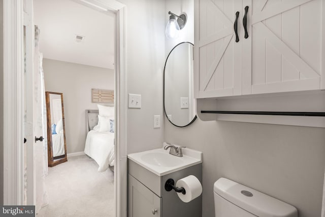 bathroom featuring toilet and vanity