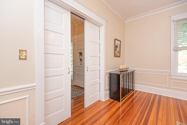 interior space with ornamental molding, wood-type flooring, and a wealth of natural light