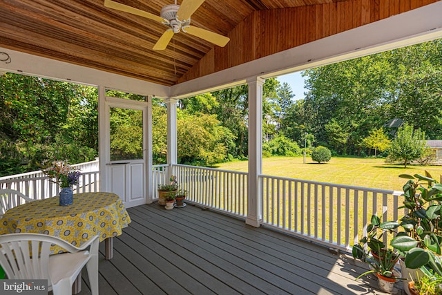 deck with a lawn and ceiling fan