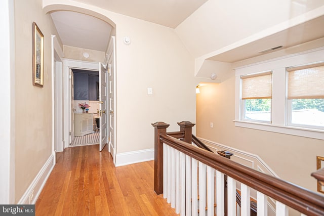 hallway with light hardwood / wood-style flooring