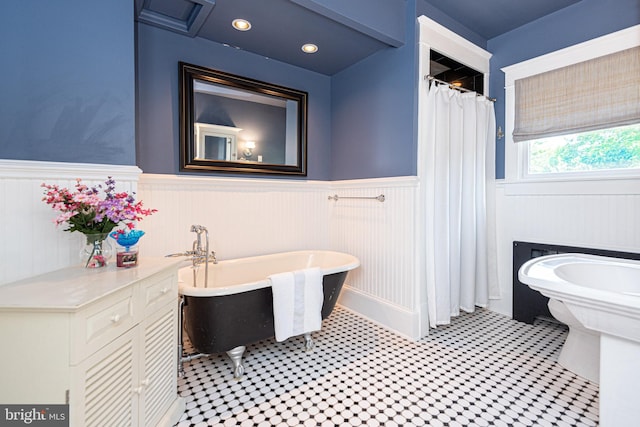 bathroom featuring toilet, shower with separate bathtub, and tile patterned floors