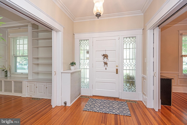 entryway featuring crown molding and hardwood / wood-style flooring