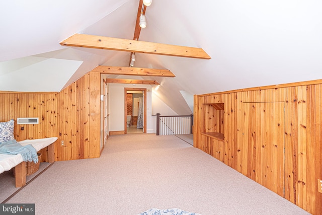 bonus room with wood walls, carpet floors, and vaulted ceiling with beams