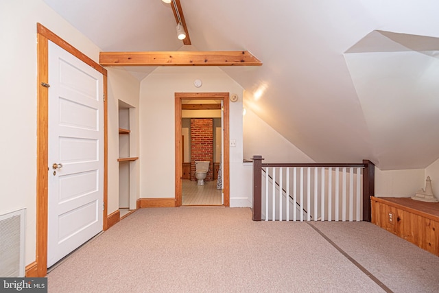 bonus room with carpet flooring and vaulted ceiling with beams