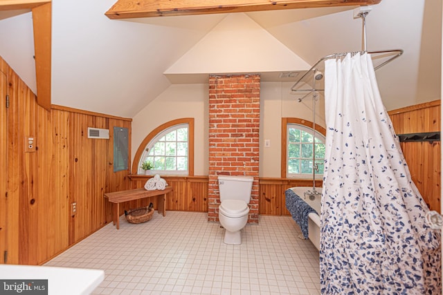 bathroom with brick wall, wood walls, toilet, lofted ceiling with beams, and electric panel