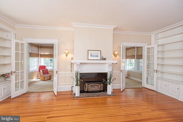 living room featuring french doors, hardwood / wood-style flooring, and a fireplace