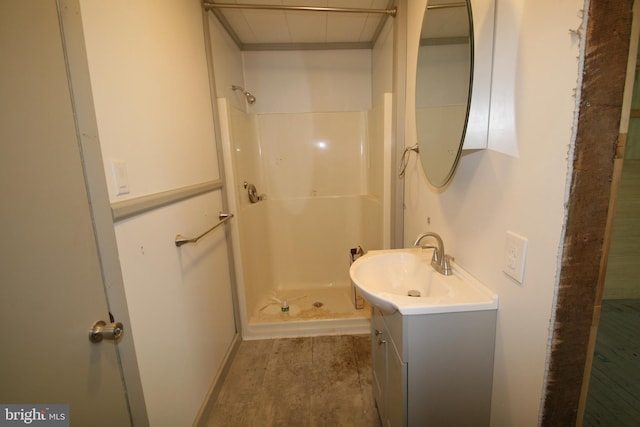 full bath with a stall shower and vanity