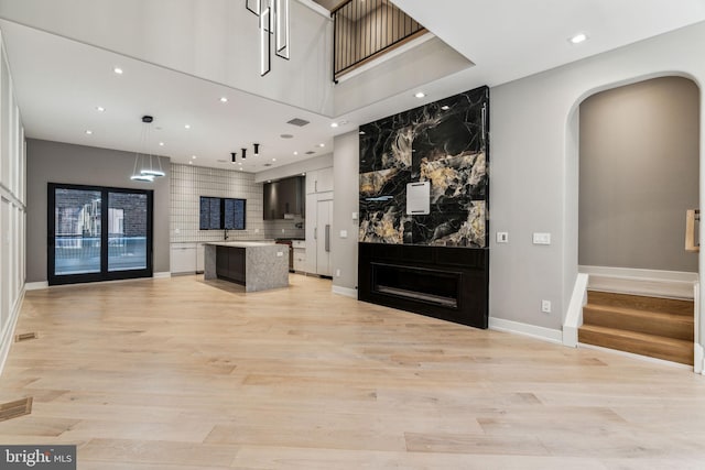 living room featuring sink and light hardwood / wood-style floors