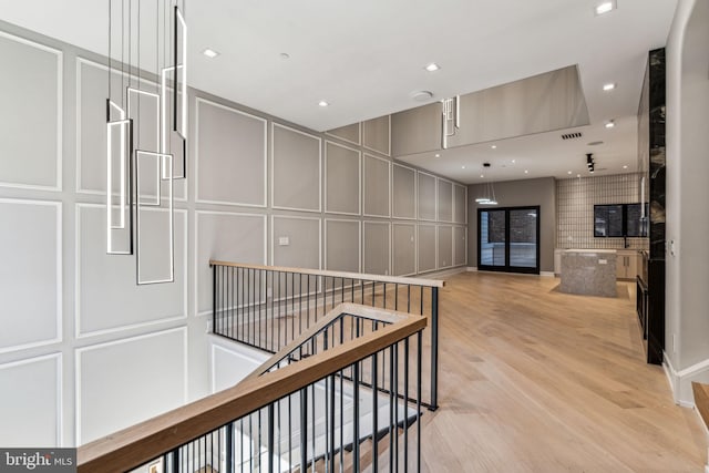 hallway with light hardwood / wood-style flooring