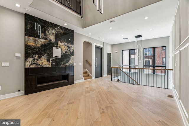 interior space featuring light hardwood / wood-style flooring and a large fireplace