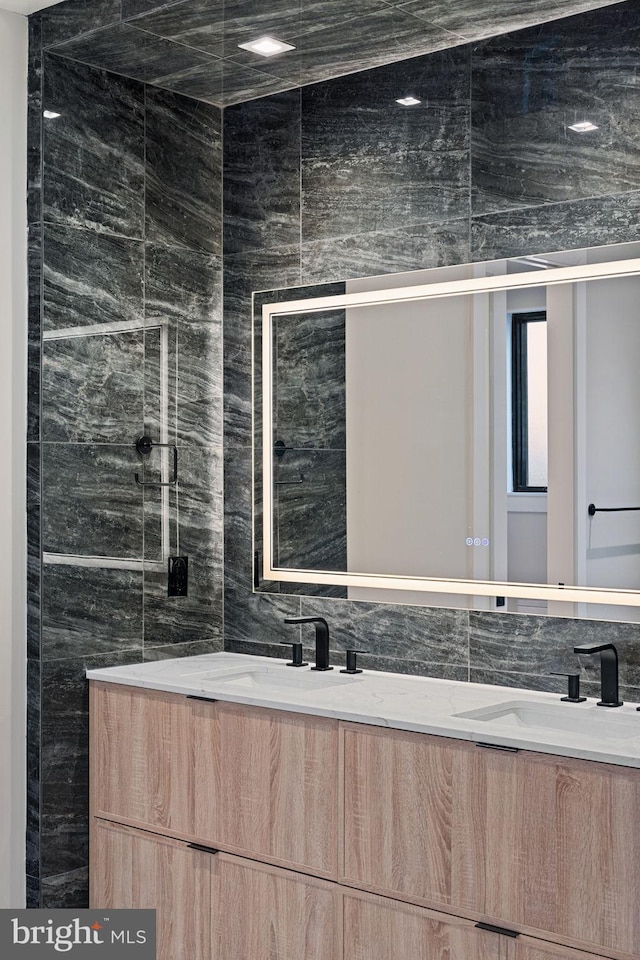 full bathroom with a sink and double vanity