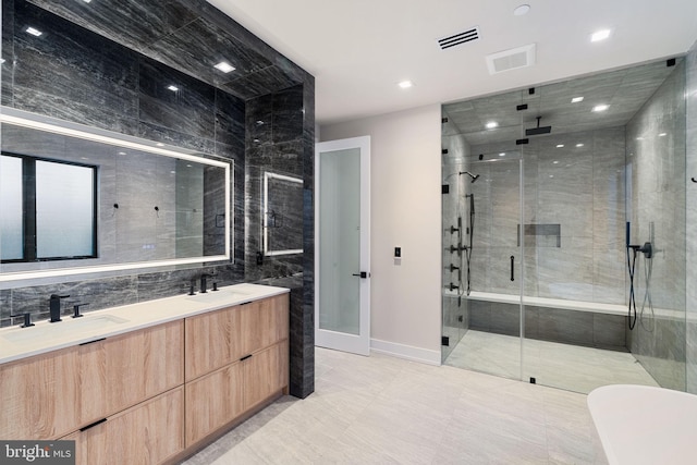 full bath featuring double vanity, a stall shower, a sink, and visible vents