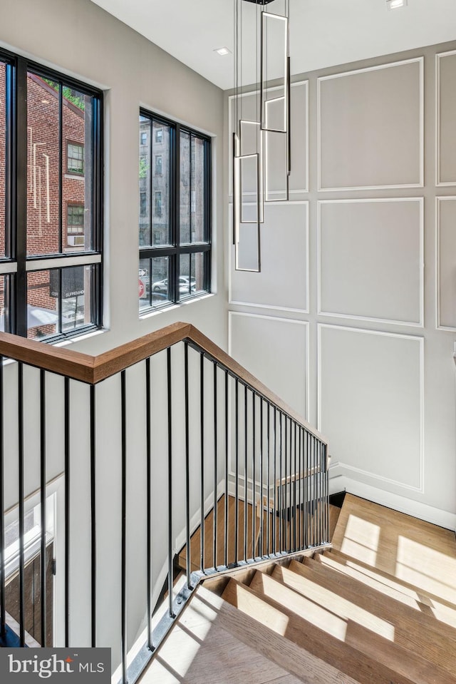 staircase with hardwood / wood-style floors