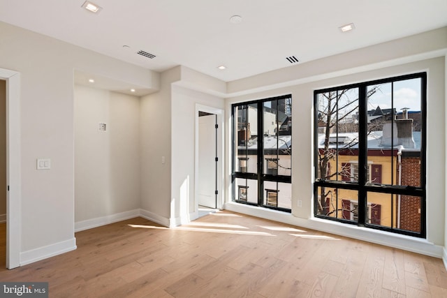 interior space with visible vents, recessed lighting, light wood-style flooring, and baseboards