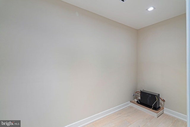 laundry room with light wood finished floors and baseboards