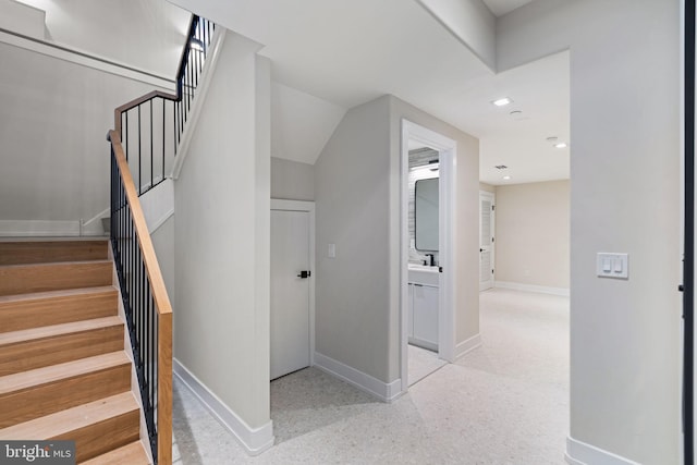 stairway with recessed lighting, baseboards, and speckled floor