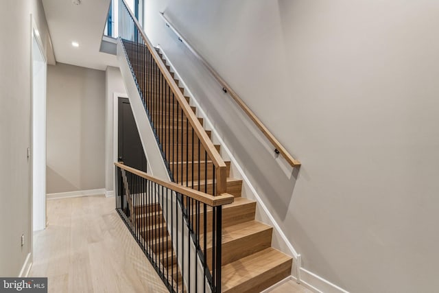 stairway with hardwood / wood-style flooring