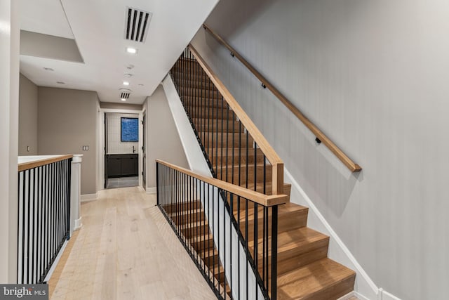 stairs featuring hardwood / wood-style flooring