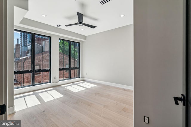 unfurnished room with ceiling fan and light hardwood / wood-style floors