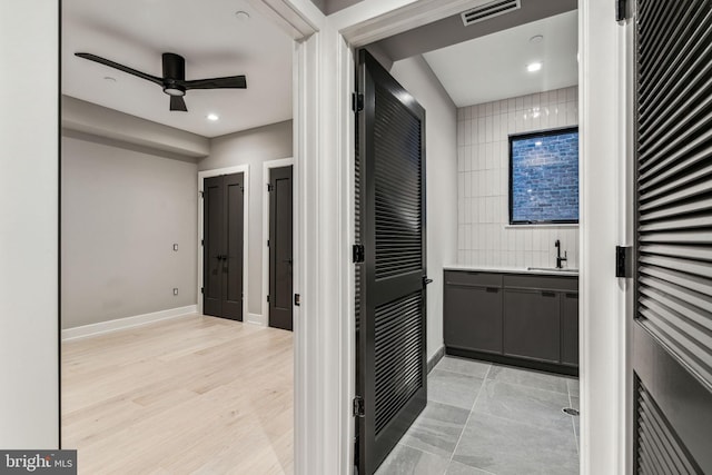 bathroom featuring ceiling fan, hardwood / wood-style flooring, and vanity