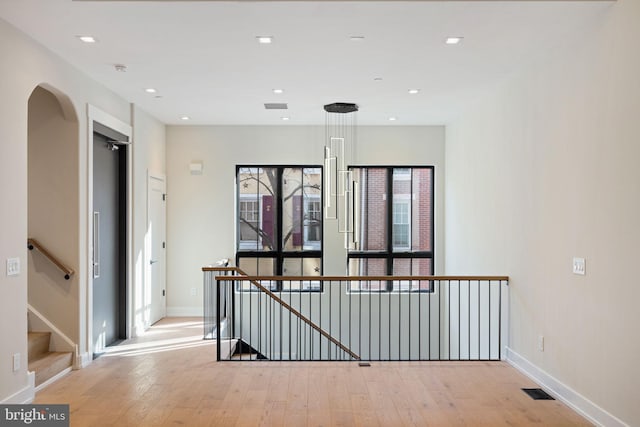 corridor with recessed lighting, light wood-type flooring, visible vents, and baseboards