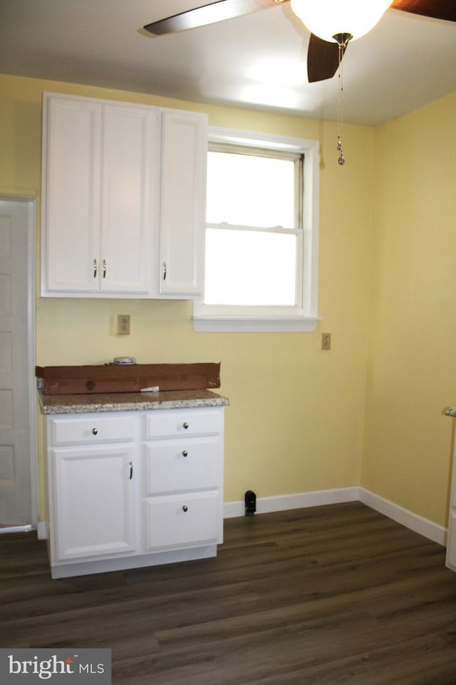 kitchen featuring ceiling fan, white cabinetry, and baseboards