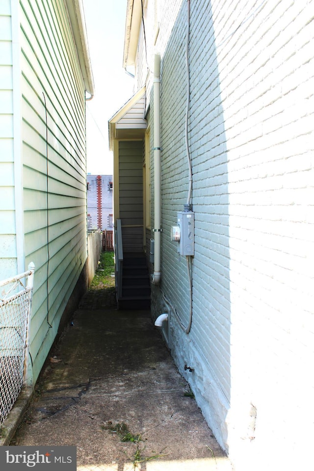 view of home's exterior with fence and brick siding