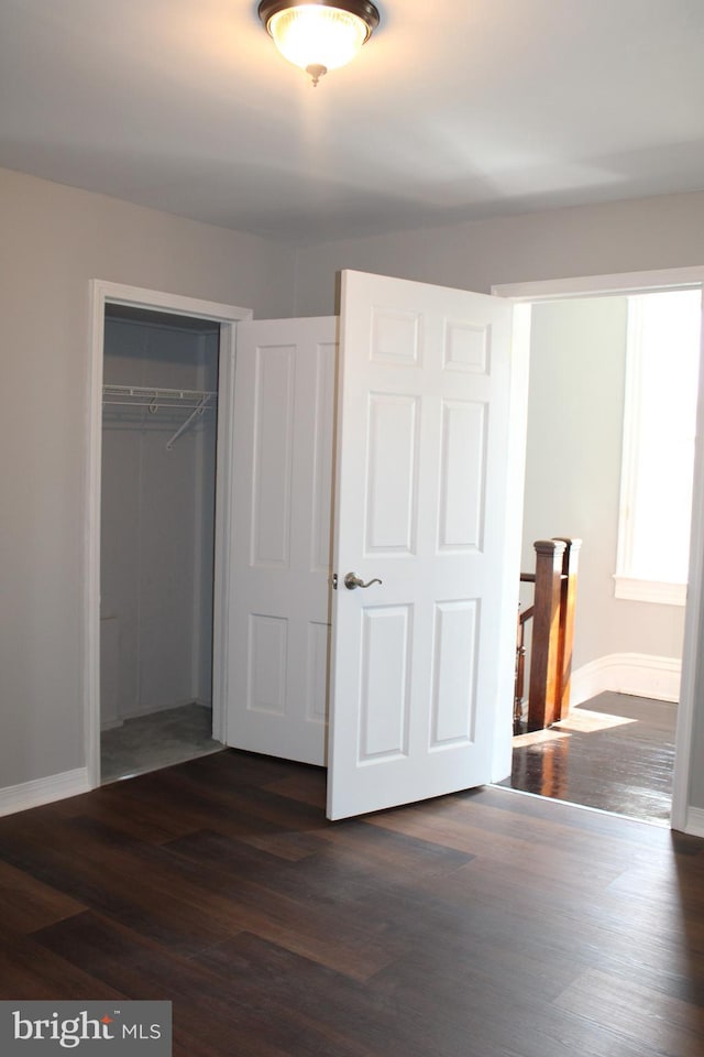 unfurnished bedroom featuring a closet and wood-type flooring