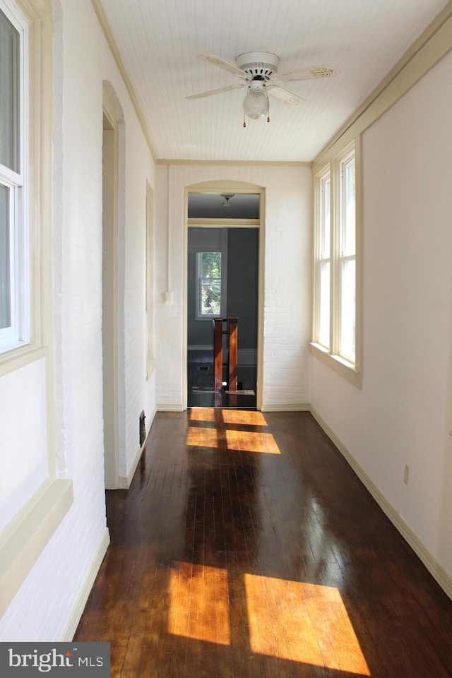 unfurnished room featuring ceiling fan, ornamental molding, and wood-type flooring