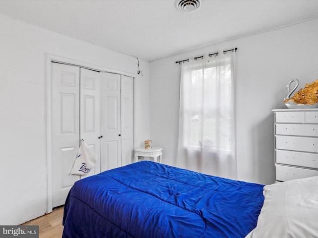 bedroom featuring a closet and light hardwood / wood-style floors