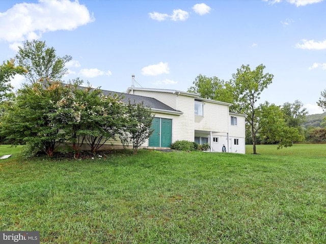 rear view of property with a yard