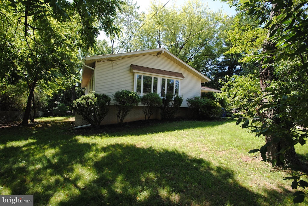 view of side of property with a lawn