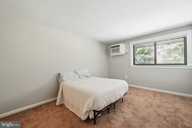 carpeted bedroom featuring an AC wall unit and baseboards