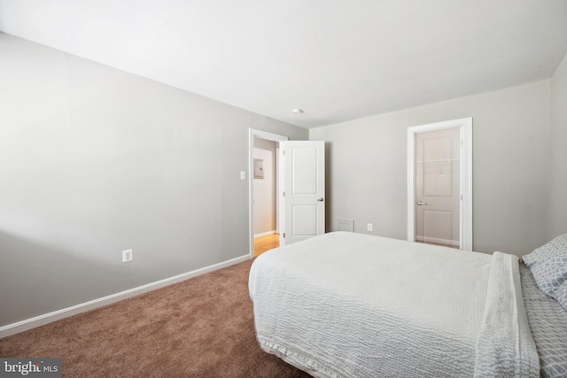 bedroom featuring carpet and baseboards