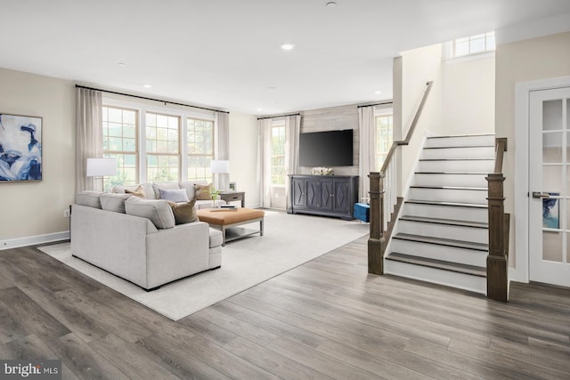 living area with stairs, baseboards, wood finished floors, and recessed lighting