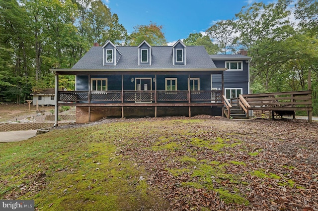 view of front of house with a chimney and a deck