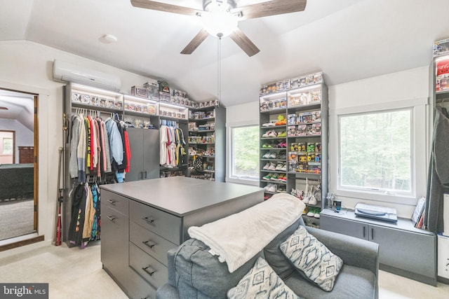 walk in closet featuring vaulted ceiling, ceiling fan, a wall unit AC, and light carpet