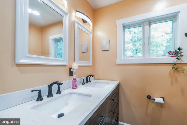 bathroom with double vanity and a sink