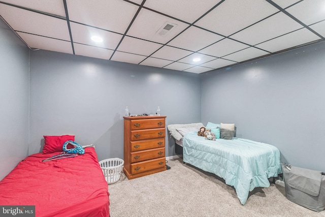 carpeted bedroom featuring a paneled ceiling, visible vents, and recessed lighting