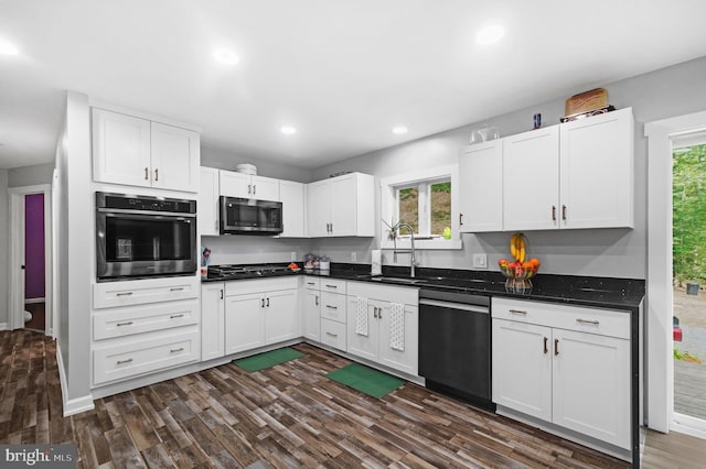 kitchen featuring a wealth of natural light, appliances with stainless steel finishes, dark wood finished floors, and a sink