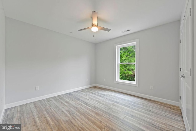 empty room featuring ceiling fan and light hardwood / wood-style flooring