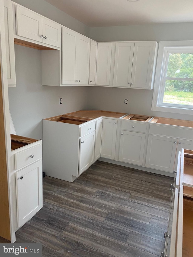 kitchen featuring white cabinetry and dark hardwood / wood-style floors